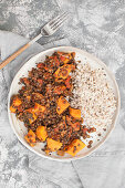 Black lentils with sweet potatoes, tomatoes and kale, served with pearls barley (Vegan dish)