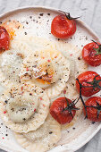Spinach and mascarpone ravioli served with roasted cherry tomatoes, grated parmesan and ground black pepper