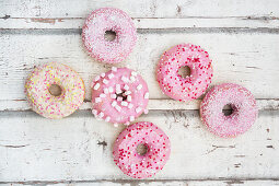 Doughnuts with pink sugar glaze and sugar decorations