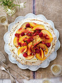 Pavlova with pistachios, nectarines, cream and raspberries for Christmas