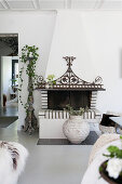 Open fireplace with ornate metal decoration in living room