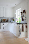 White country-house kitchen with panelled walls