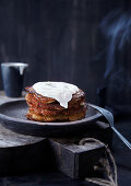 A stack of potato pancakes with sour cream