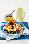 Kokos-Pancakes mit Bacon und Blaubeeren in Ahornsirup zum Brunch