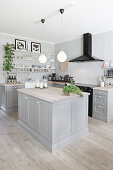 Open-plan, country-house-style kitchen in grey
