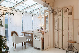 Shabby-chic living room in modern conservatory