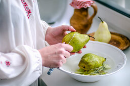 Pear in the hands of hostess