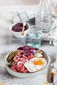 Lobscouse with soused herring, fried egg, beetroot and gherkins