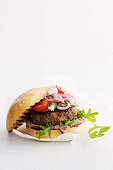 A lamb burger with Greek salad