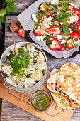 Potato salad, couscous with strawberries and grilled flatbread
