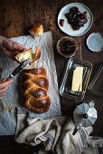 Challah bread (Jewish cuisine) with butter and jam on a breakfast table
