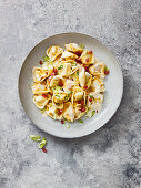 Tortelloni with bacon, spring onions and a creamy sauce