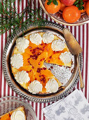 Cheesecake with pommergrante, mandarin and whipped cream