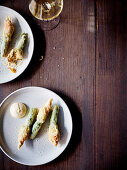 Fried and zucchini flowers stuffed with almond puree and Aioli