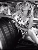 A blonde woman and a kid sitting in a car