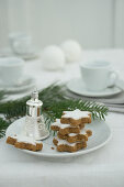 Cinnamon stars and Christmas decorations on a plate