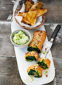 Avocado and salmon rolls with oriental herbs, a cream cheese and wasabi dip and grilled bread