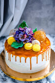 A festive cake with macaroons and flowers