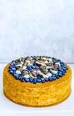 A blueberry cake decorated with chocolates