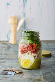 Layered salad with vegetables and egg in a jar