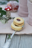 Jam sandwich biscuits on a spoon