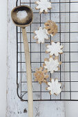 Iced flower-shaped cinnamon biscuits on a wire rack