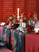 Table festively set for Christmas in red and black