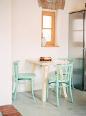 Small breakfast table with mint-green chairs
