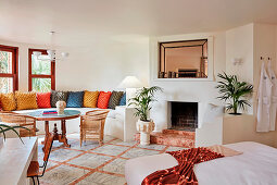 Brick corner bench with colorful pillows in the fireplace room