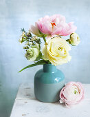 Bouquet of ranunculus in blue vase