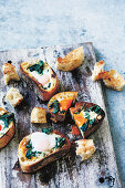 Pan fried slices of bread with spinach, feta and eggs