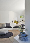 Cushions on masonry bench in white lounge