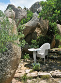 Seating area surrounded by granite boulders in garden
