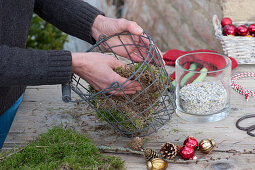 Candle arrangement in a wire basket as Advent wreath