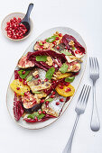 Radicchio salad with fish, oranges and pomegranate seeds