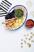 Chips, crackers and breadsticks with dips for New Year's Eve