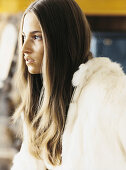 Young woman wearing off-white hooded jacket
