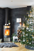 Fireplace and Christmas tree in living room with slate-clad walls