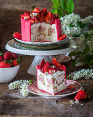 Strawberry profitrole cake with cream cheese mousse and strawberry cream inside profitroles