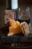 Cheese board still life with cheddar, crackers and wine
