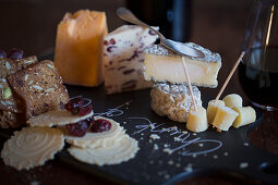 Cheese board still life with crackers, cranberries and wine