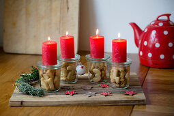 Alternative Advent wreath made from candles on mason jars containing biscuit numbers 1-4