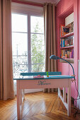 Old school desk painted and decorated with name in girl's bedroom