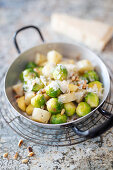Brussels sprouts with Jerusalem artichoke and parmesan in a pan