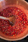Lingon berry jam being made, lingon berries being heated in a pot