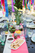 Potted succulents on table set in bright colours for Mexican party