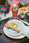 Breadstick on plate on table set for Mexican party