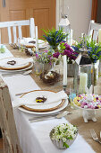 Flower arrangements on festively set Easter table