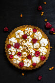 Lemon tart with meringue and raspberries