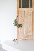 Festive wreath of eucalyptus leaves on wooden door